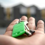 Close-up picture of someone's hand with apartment keys in it