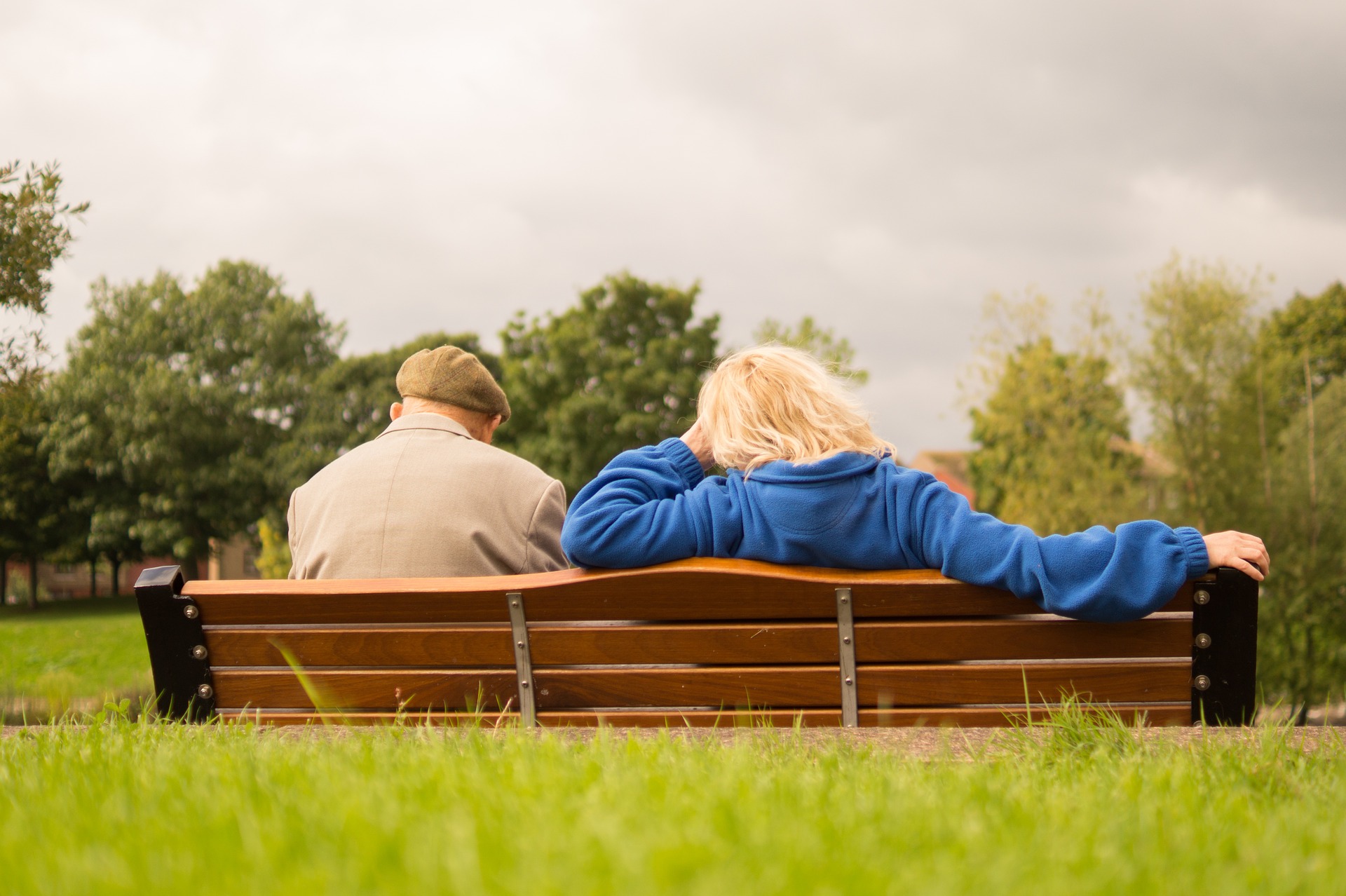 Elderly couple sitting on bench at the park